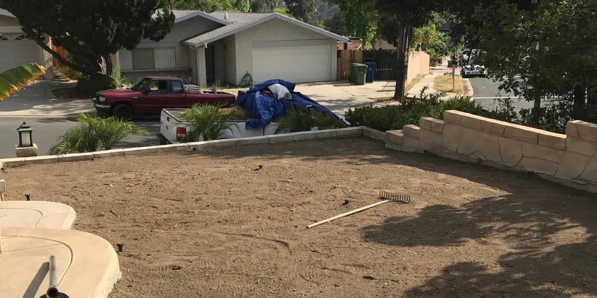 Bare dirt yard prepared for sod installation