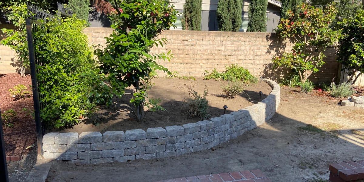 Finished retaining wall holding a level terrace above